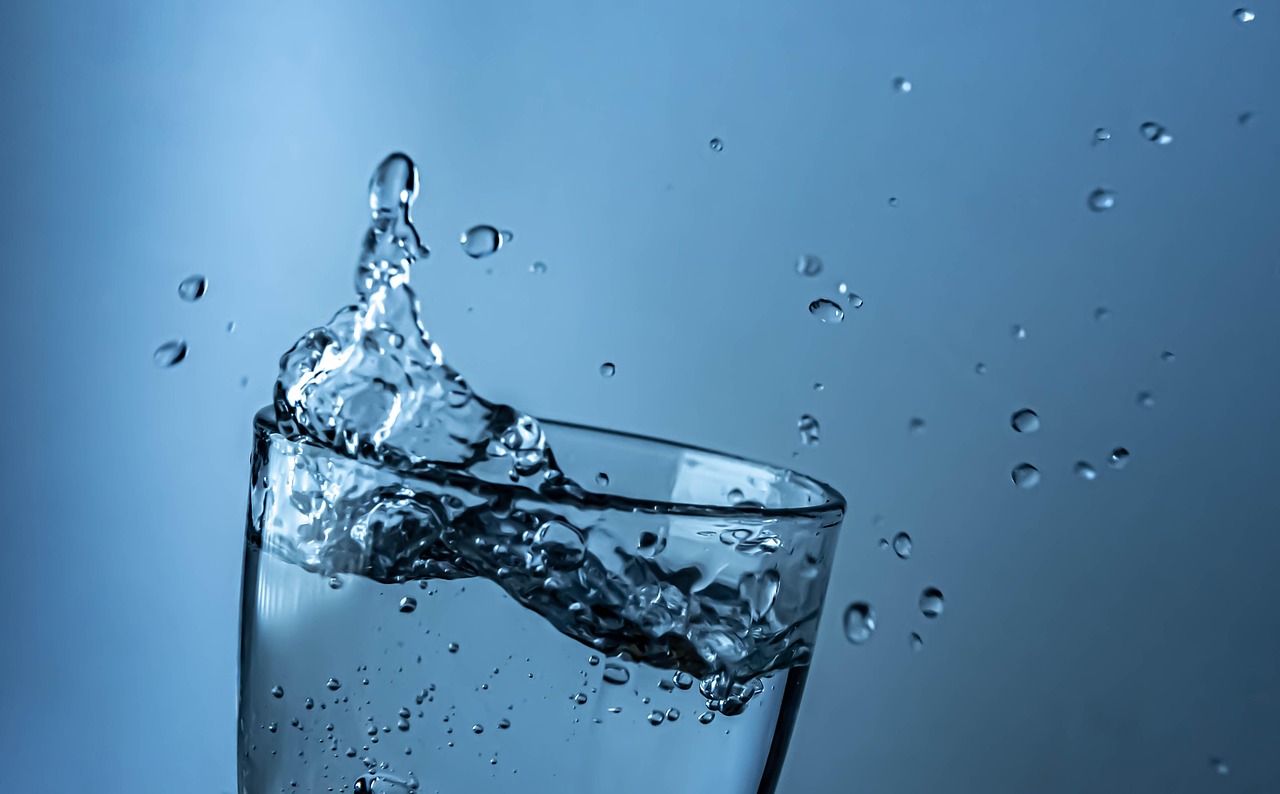 Clean filtered drinking water splashing in a glass
